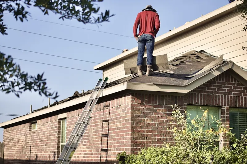 Professional roofer working on a residential roof in Heshbon